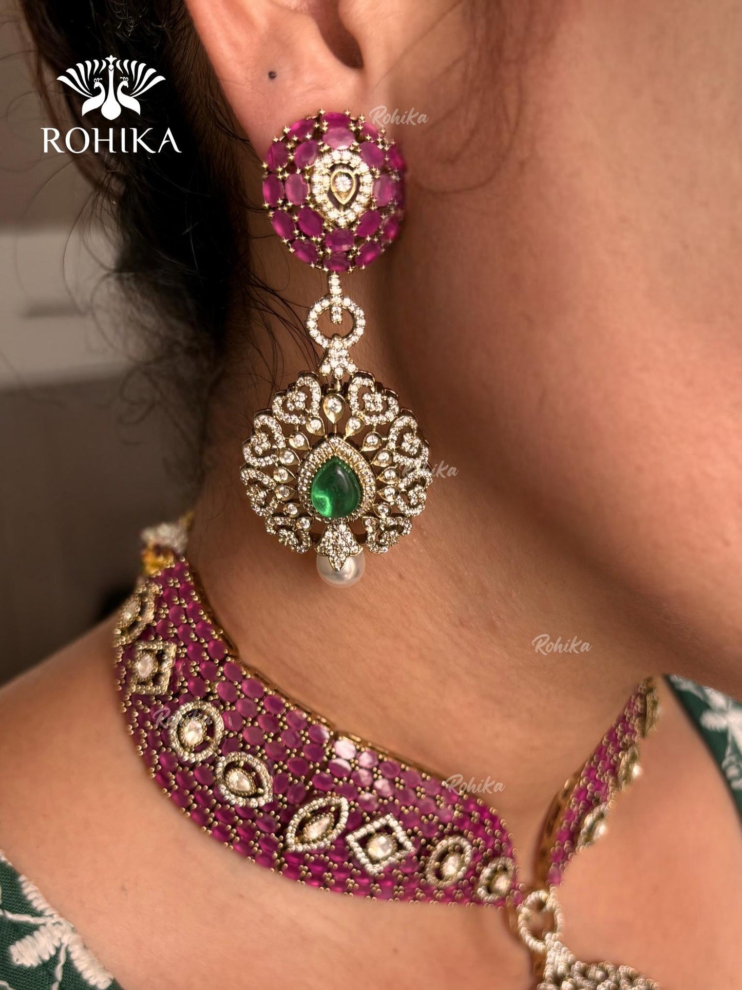 Pink and green color kundan necklace set on a grey dummy