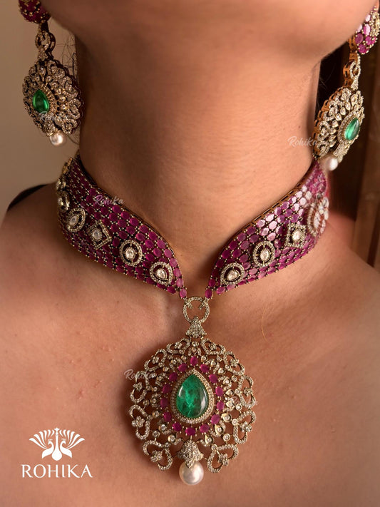 Pink and green color kundan necklace set on a grey dummy