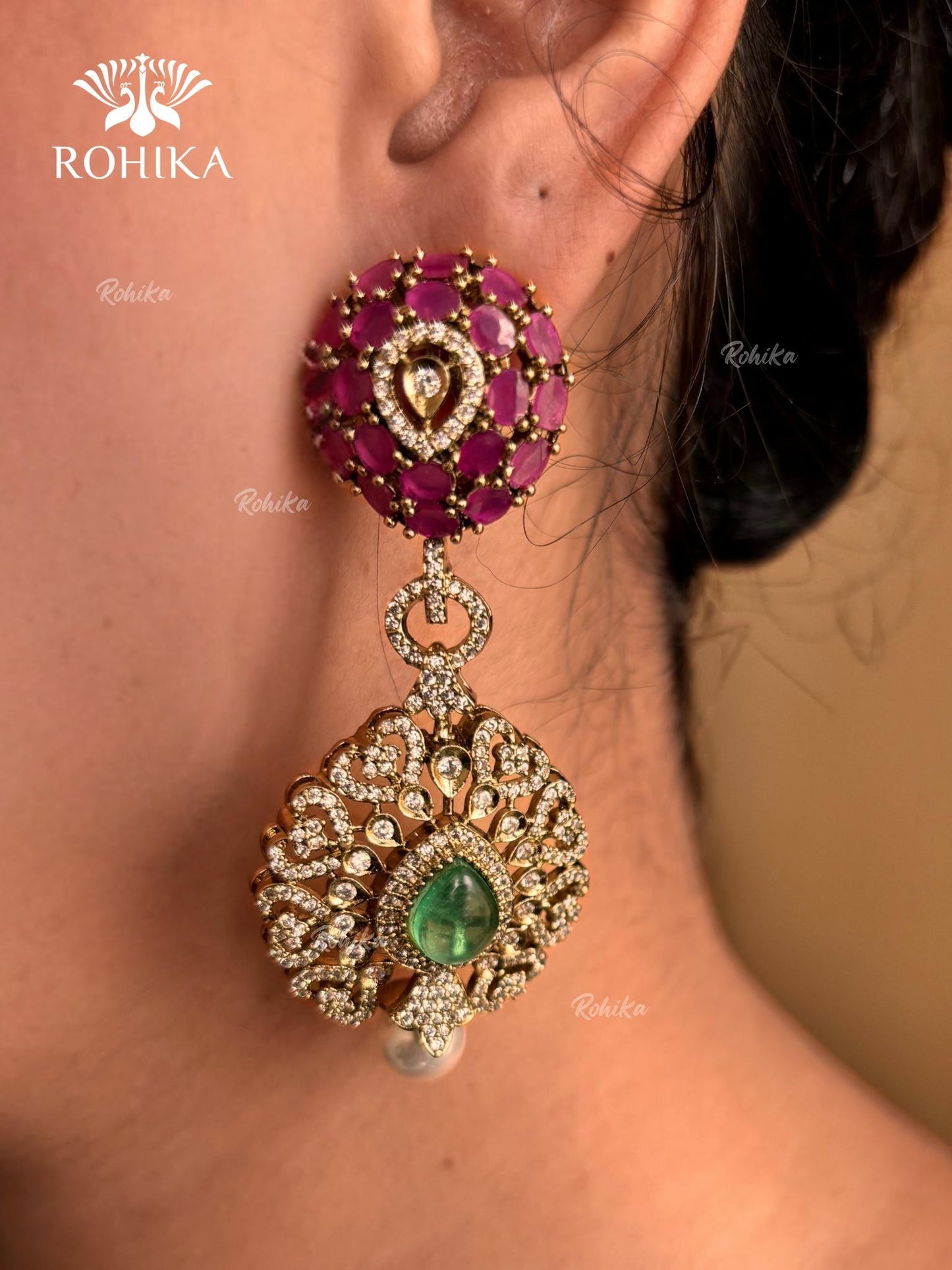 Pink and green color kundan necklace set on a grey dummy