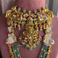 Ornate gold and green necklace on a mannequin with 'Rohika' branding.