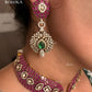 Pink and green color kundan necklace set on a grey dummy