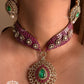 Pink and green color kundan necklace set on a grey dummy