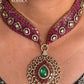 Pink and green color kundan necklace set on a grey dummy